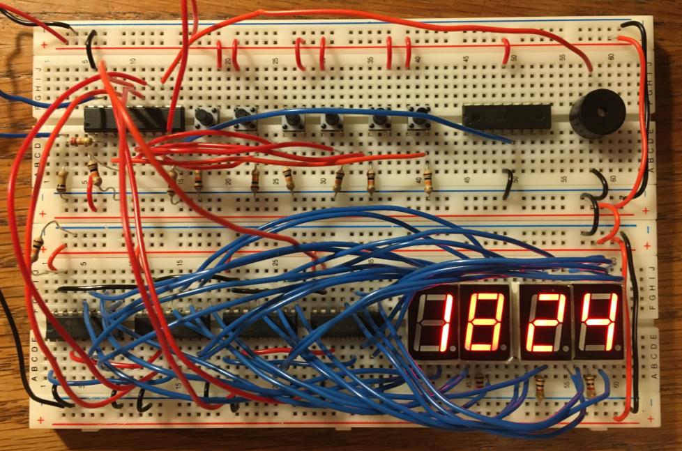 The breadboard prototype: all four seven-segment displays wired up and running, reading “18:24”