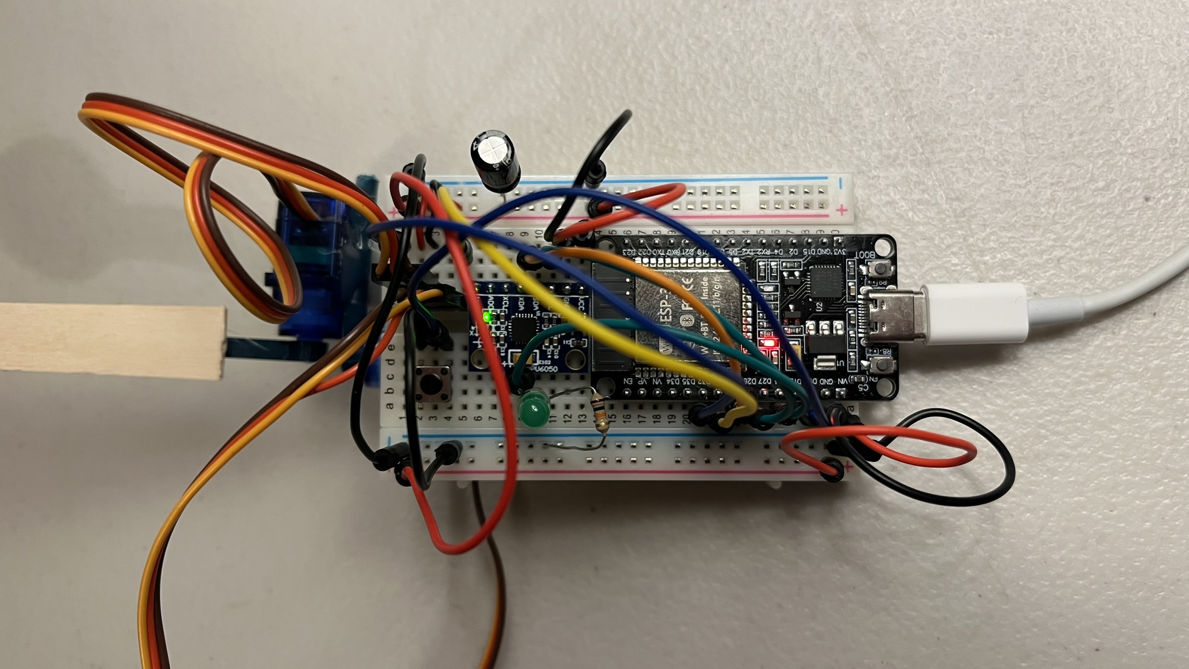Breadboard wiring close-up: MPU6050, button, LED, and servo signal lines