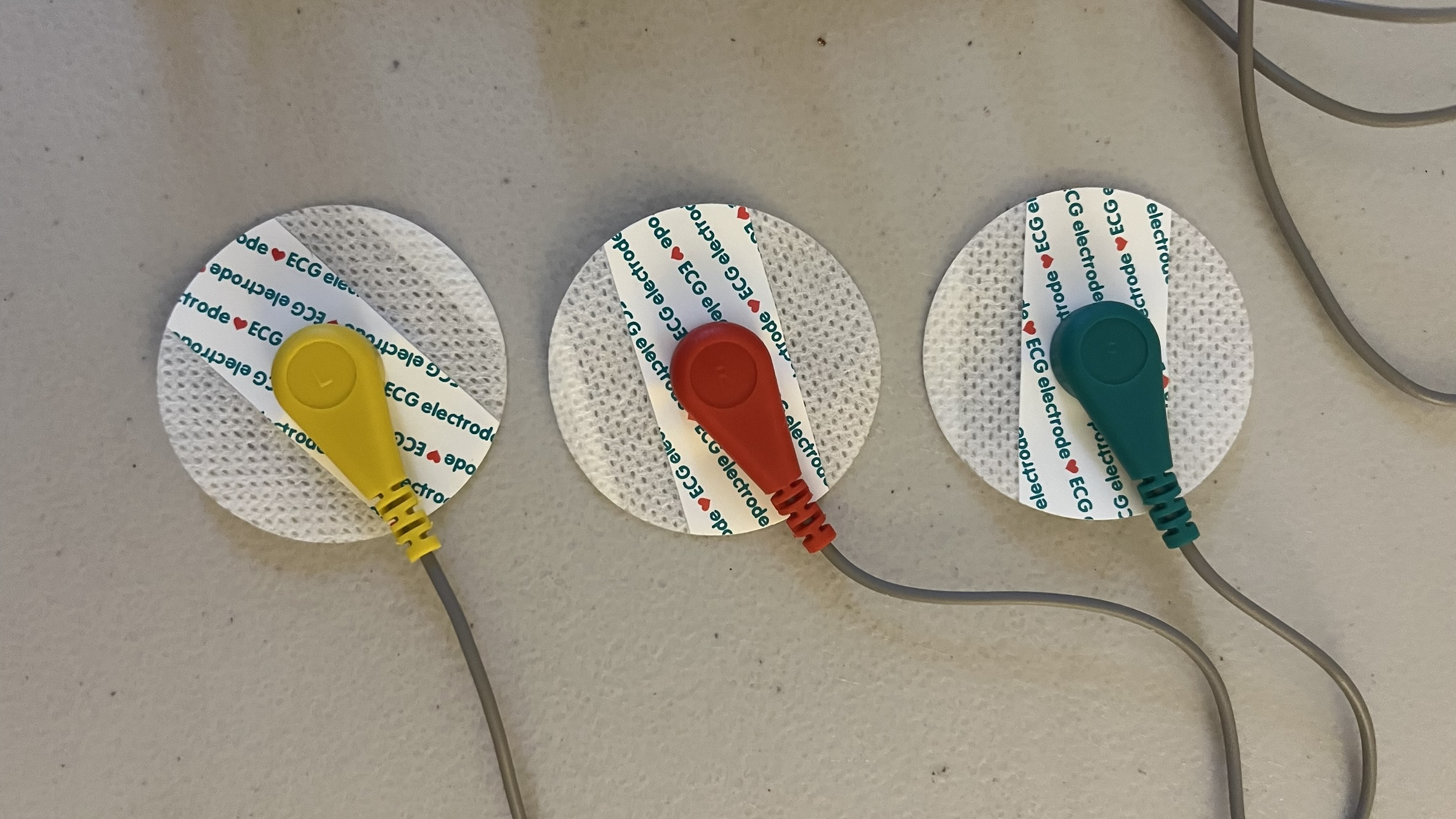 The three ECG electrode pads before being attached